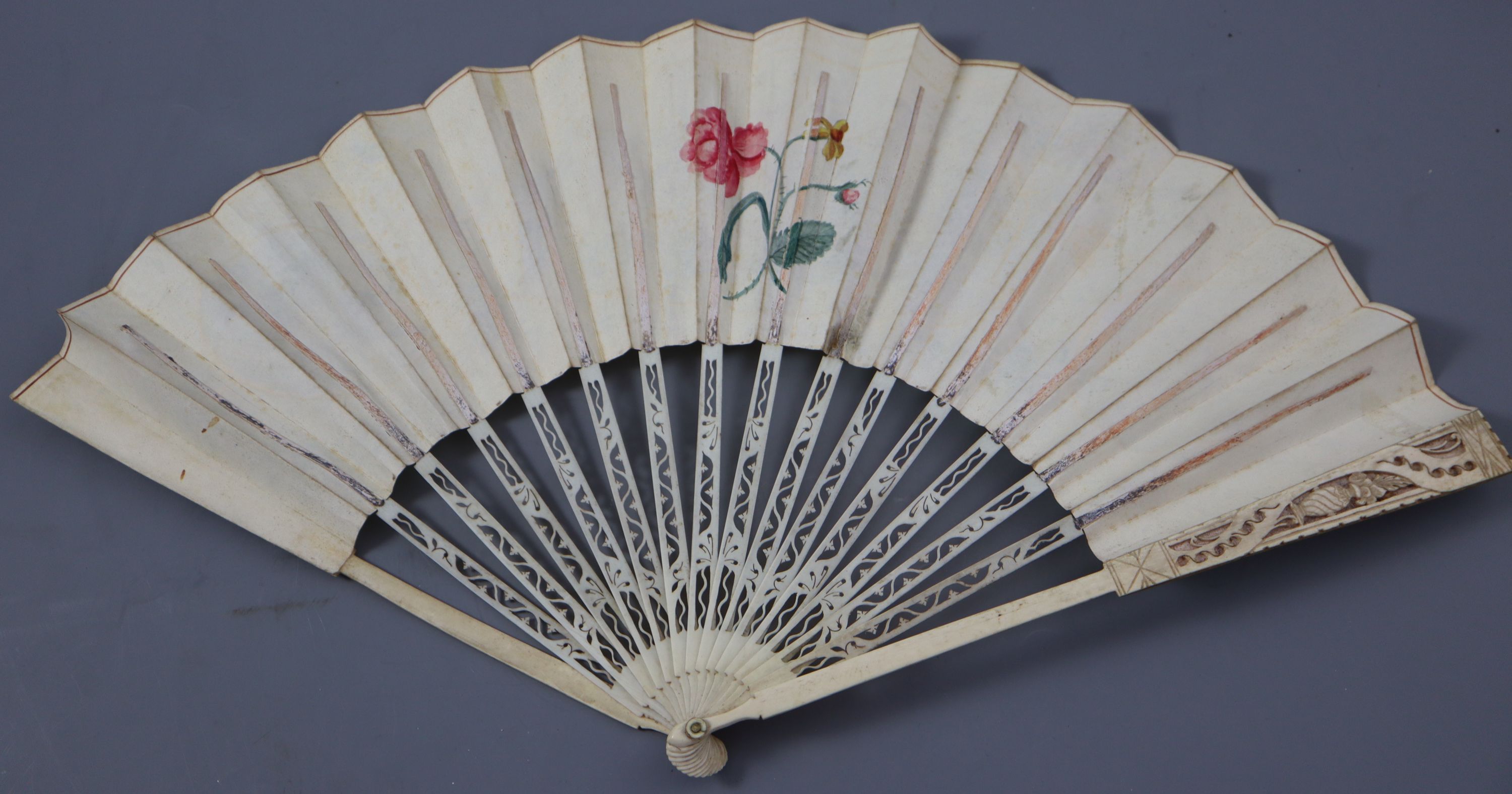 An early 19th century English bone, ivory and chicken skin fan and an Oskar Zeibig fan